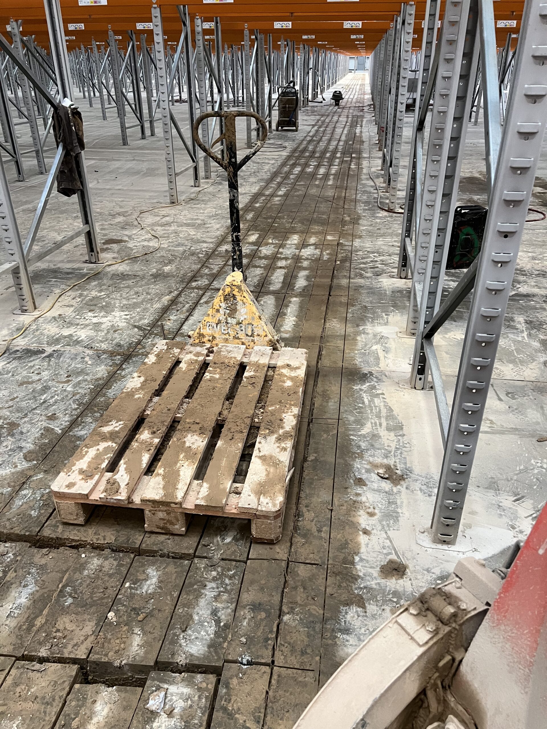 The concrete was cut into very small sections and lifted out with the pallet ruck as we had to work underneath and around the racking system, without damaging it