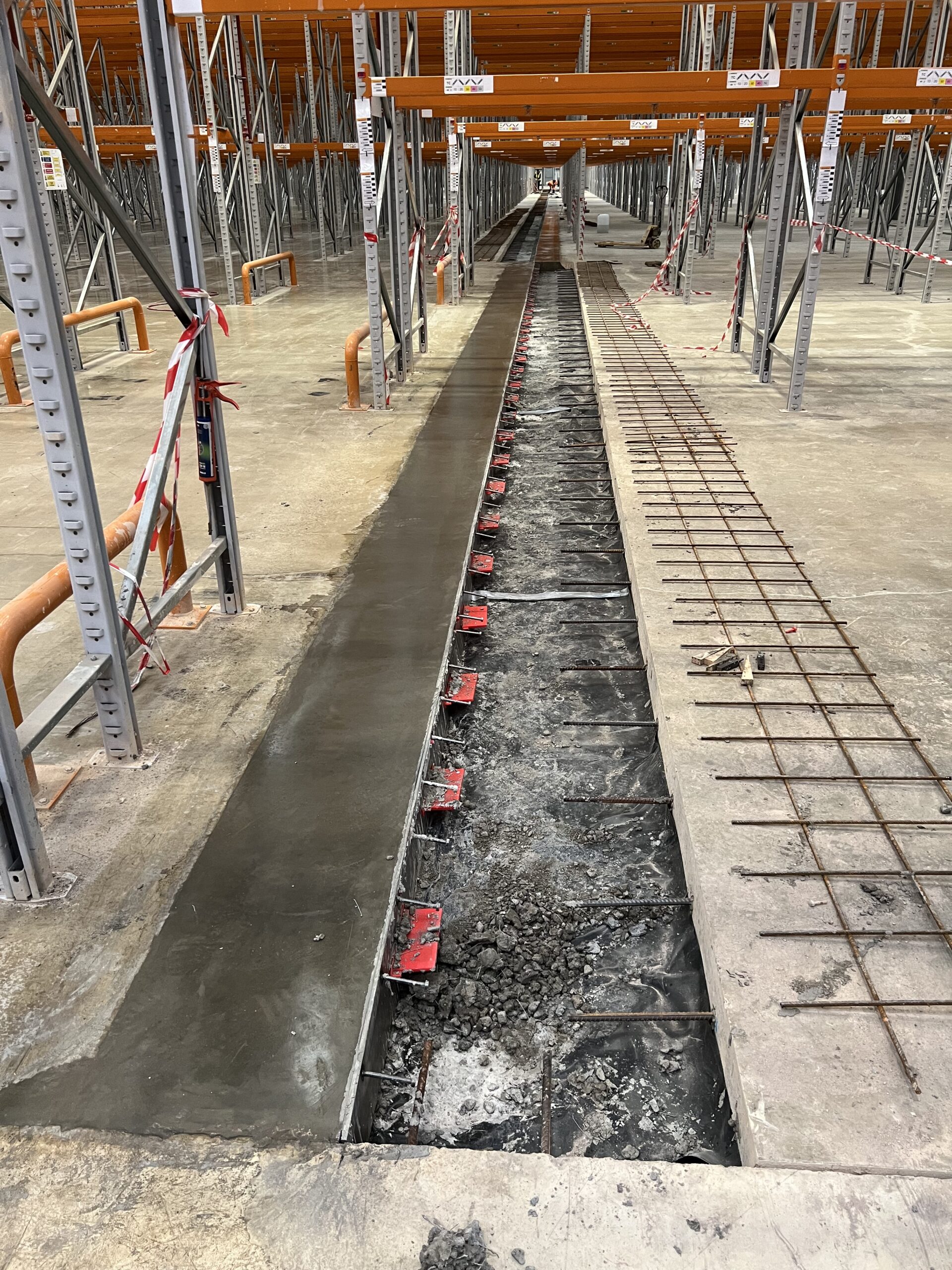 This photo is showing the new joint being installed. Concrete has been poured and power floated smooth and level to one side of the joint. The other side of the joint is poured the next day and subsequently laid level.